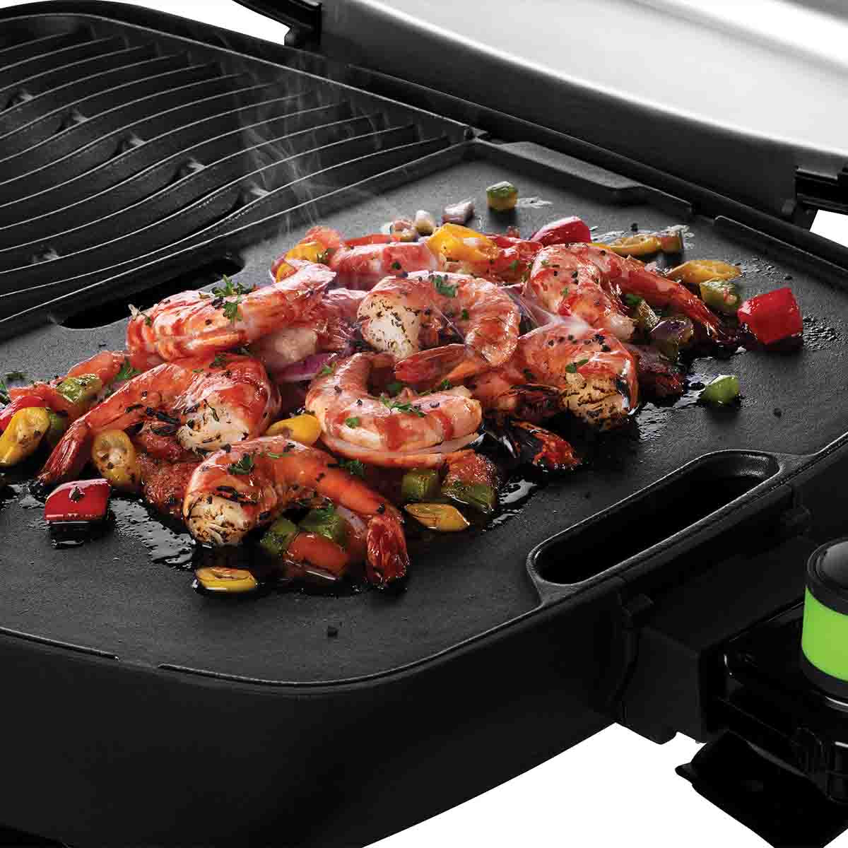Detaljbilde av fettavløpsåpning på Grillplate støpejern for TravelQ 285 37x27 cm - Napoleon